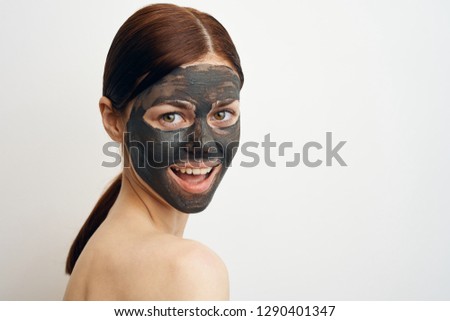 beautiful woman in a cosmetic mask