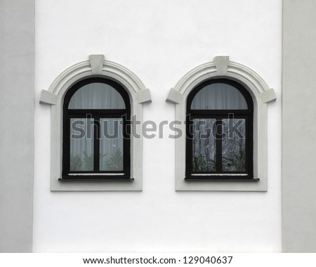 house front with two arched windows, retro style