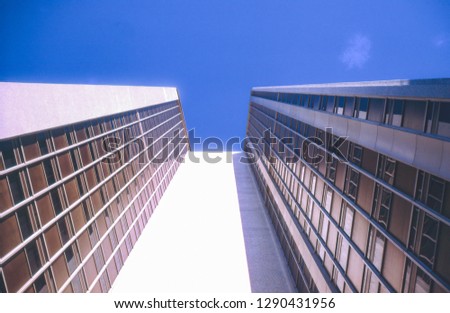 Vintage photo circa 1960s, skyscraper in Sydney Australia. Viewed from below looking up to blue sky. From a 35mm slide.