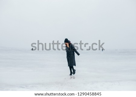 Woman walk in the forest with cup of coffee or thermos of hot tea. Fresh and frost air in the winter