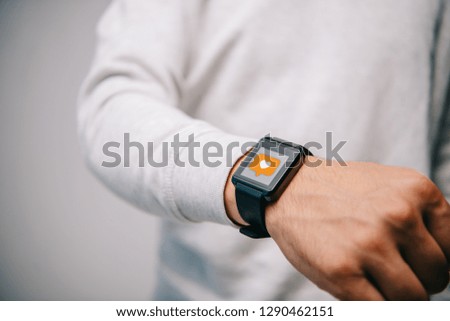 cropped view of man with smartwatch with multimedia like icon