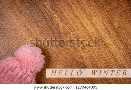 Kids Winter Hat On Wooden Background With Winter Quote. Place for your text. Image