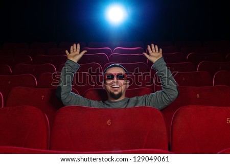 Funny  man in 3D glasses watching movie in cinema