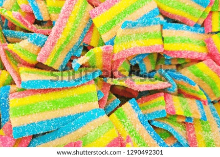 Colorful fruit jelly sweets with sugar texture background. Bright gummy candies close up photography