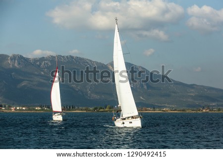 Sailing in the wind through the waves at the Sea. Yachts.