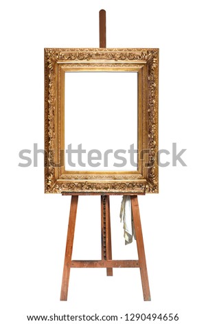 Painter's easel and empty antique golden frame isolated with clipping path