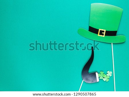 Creative st Patricks Day green background. Flat lay composition of Irish holiday celebration with photo booth decor: glasses, bow tie, moustache. With Copy space, greeting card, top view Royalty-Free Stock Photo #1290507865