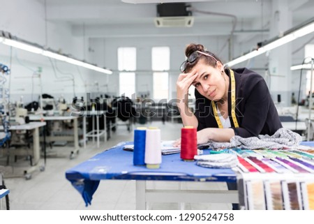 Adult woman posing in factory.