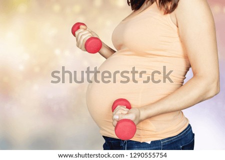 Portrait of cute brunette pregnant woman do fitness in gymnasium, sporty lifestyle, health care, happy and healthy pregnancy concept