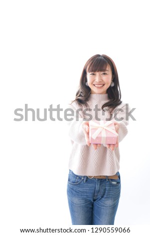 Young woman giving a box