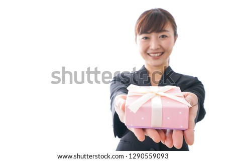 Young woman giving a box