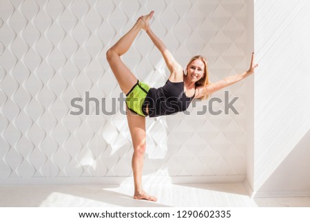 Young happy fitness model woman athlete  doing stretching workout near sunny solar bright wall. Healthy life bodybuilding lifestyle concept image, copy space. White empty background for text.