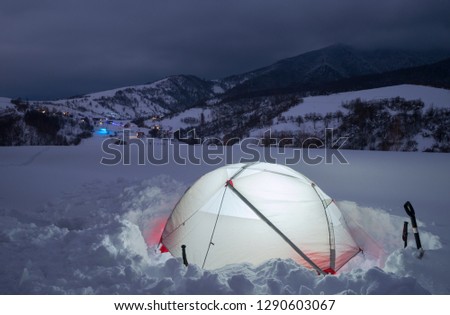 Tourist tent in night winter mountains. Carpathians