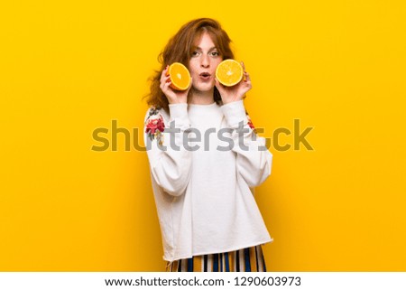 Young redhead woman with orange slices