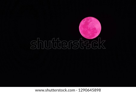 Pink moon, black background