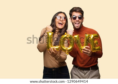 Young couple in valentines day surprised and shocked
