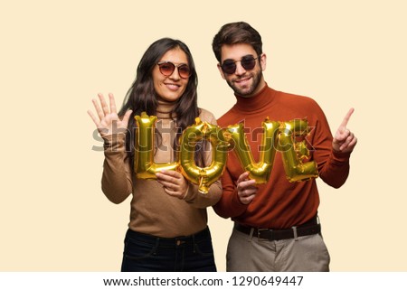 Young couple in valentines day showing number six