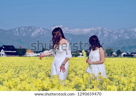 Girls and canola flower in the farm, photo taken at a small village, Japan