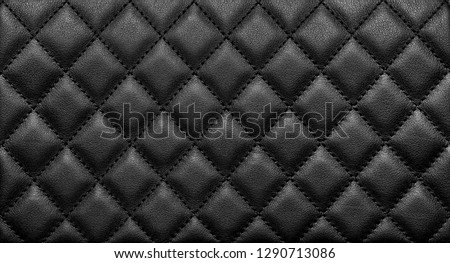 Close-up texture of genuine leather with black rhombic stitching. Luxury background Royalty-Free Stock Photo #1290713086