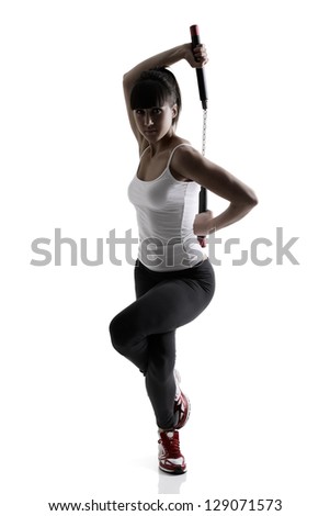 sport karate girl doing exercise with nunchaku, fitness silhouette studio shot over white background