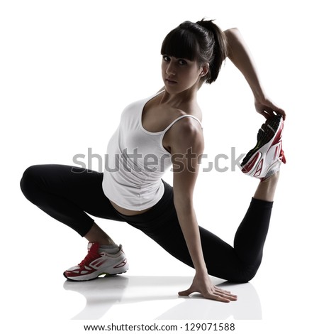 portrait of sport girl doing yoga stretching exercise, studio shot in silhouette technique over white background