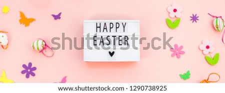 Creative Top view flat lay holiday composition Happy Easter text on lightbox pink paper background copy space Template Easter day seasonal pattern