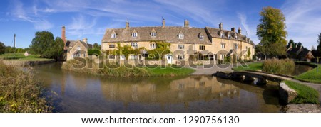 Stitched panorama of the idyllic Cotswold cottages in early autumn by the little River Eye in Lower Slaughter, Gloucestershire, UK