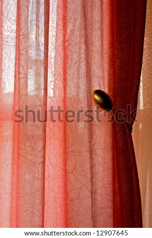 Interior decoration detail showing a curtain on natural background light
