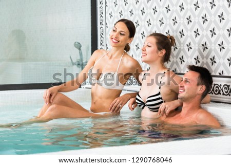 Three smiling cheerful  friends relaxing at spa, enjoying company