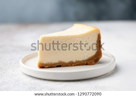 Slice Of Classical New York Cheesecake On White Plate. Closeup View Royalty-Free Stock Photo #1290772090