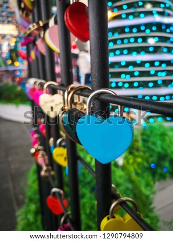 Couple red heart lock with key lean against vintage pole, vlentine love symbol.