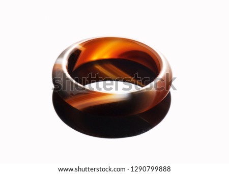 Amber color ring on white with reflection