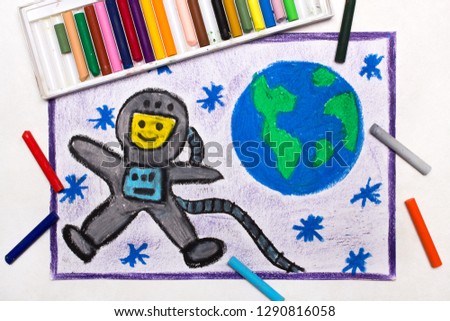 Colorful drawing: Happy astronaut in spacesuit flying next to the planet earth