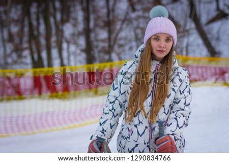 beautiful girl in Hat skiing on snow background.
