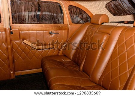 interior of the car is a brown color and leather