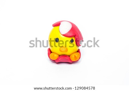 Red baby chicken with Easter eggs colour plasticine crafts on a white background.