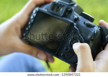 Young latin woman looking at photo camera in the park. Professional woman working. Outdoors
