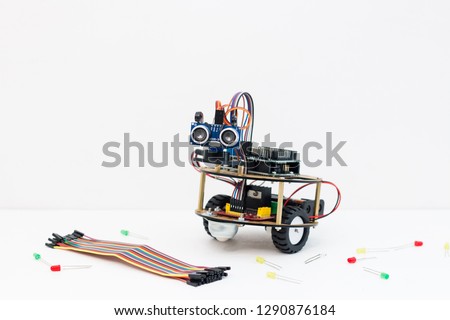 Hand made robot working on the arduino platform. White background. Free space for text. STEM education for children and teenagers, robotics and electronics. DIY. AI. STEAM. Royalty-Free Stock Photo #1290876184
