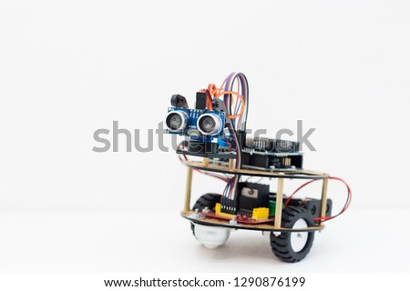 Hand made robot working on the arduino platform. White background. Free space for text. STEM education for children and teenagers, robotics and electronics. DIY. AI. STEAM. Royalty-Free Stock Photo #1290876199