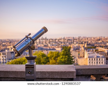 Telescope at Sacre Coeur church to view cityscape of Paris