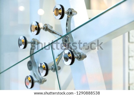 Fastening of glass walls. Architecture abstract background. Glass curtain walls. The elements of the fastener system metal glass spider. Front Windows Royalty-Free Stock Photo #1290888538