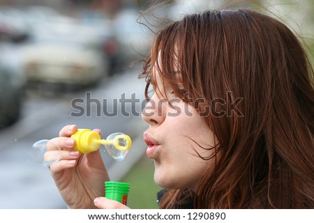 The girl starts up soap bubbles