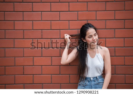 Portrait of beautiful asian chic girl pose for take a picture on wall background,Lifestyle of teen thailand people,Modern woman happy concept