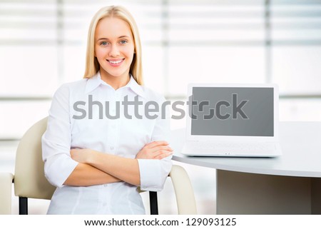 Portrait of a young business woman using laptop at office