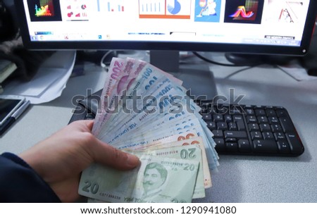Hands holding turkish lira bills