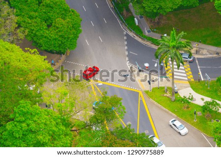 Aerial view of road traffic in Singapore. People crossing the road