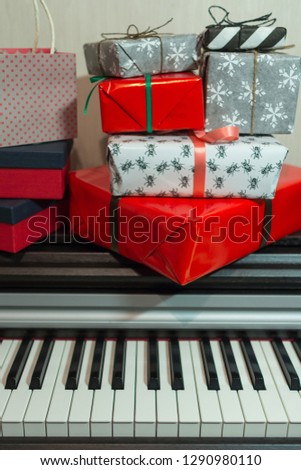Colorful gift boxes on the piano. Christmas holidays decoration of Interior.