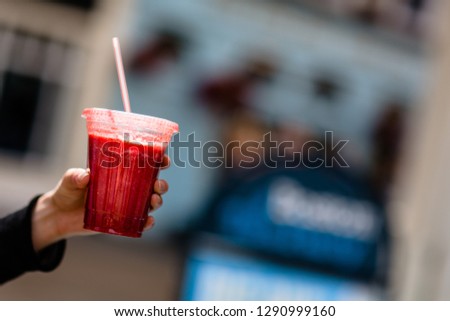 Woman holding healthy smoothie