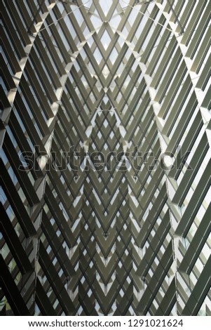 Double exposure photo of glass ceiling with steel framework. Generic structural glazing of industrial or office building. Abstract background on the subject of modern architecture or technology.