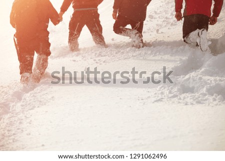 Children playing in the snow in winter